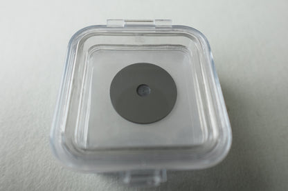 Custom zero background sample holder inside its closed packing 